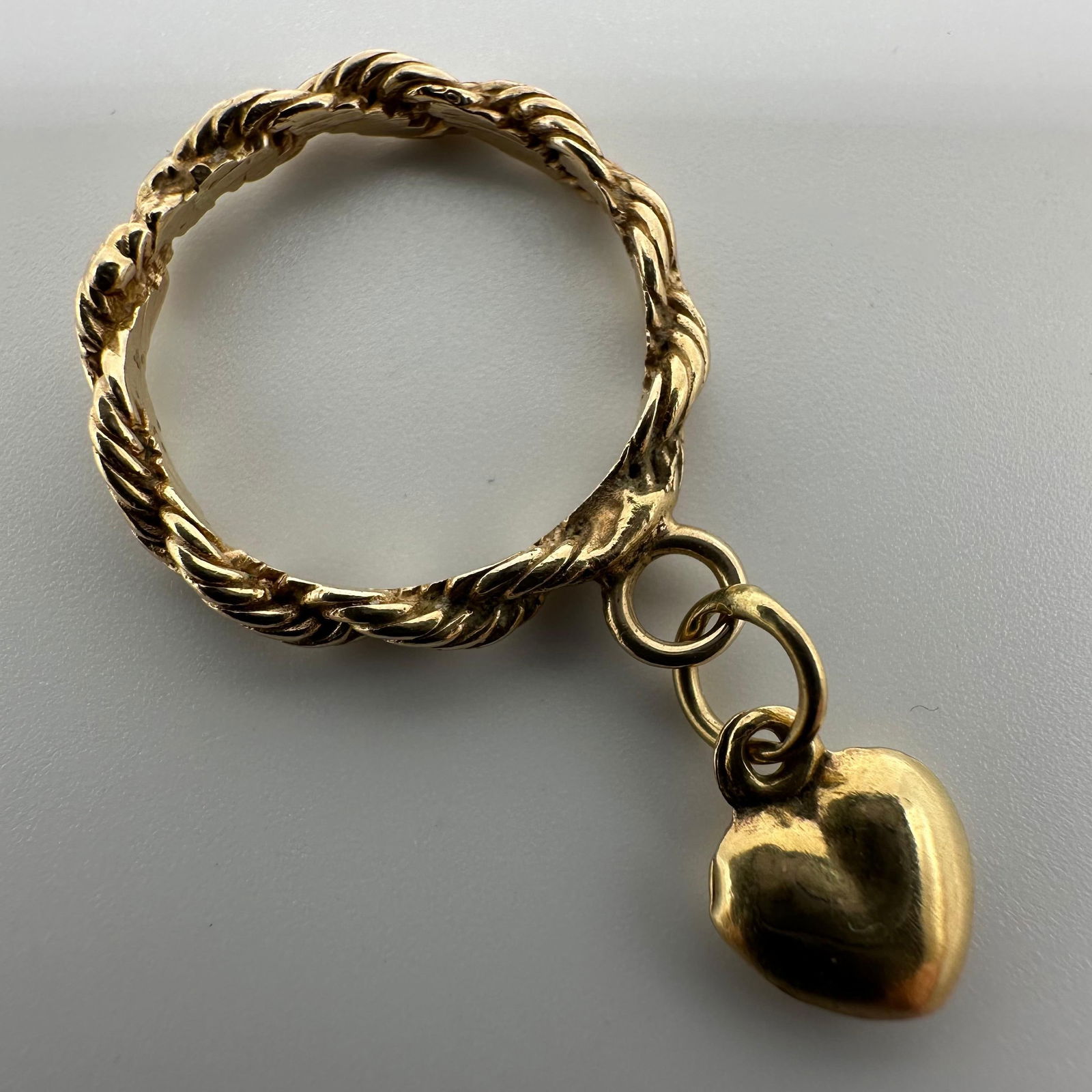 Gold Twist Rope Band 14K Puffed Heart Dangle Ring: This item is in good pre-owned, previously used/displayed condition with noticeable light wear and surface scratches. Please reference all photos for full details. This piece of jewelry has been