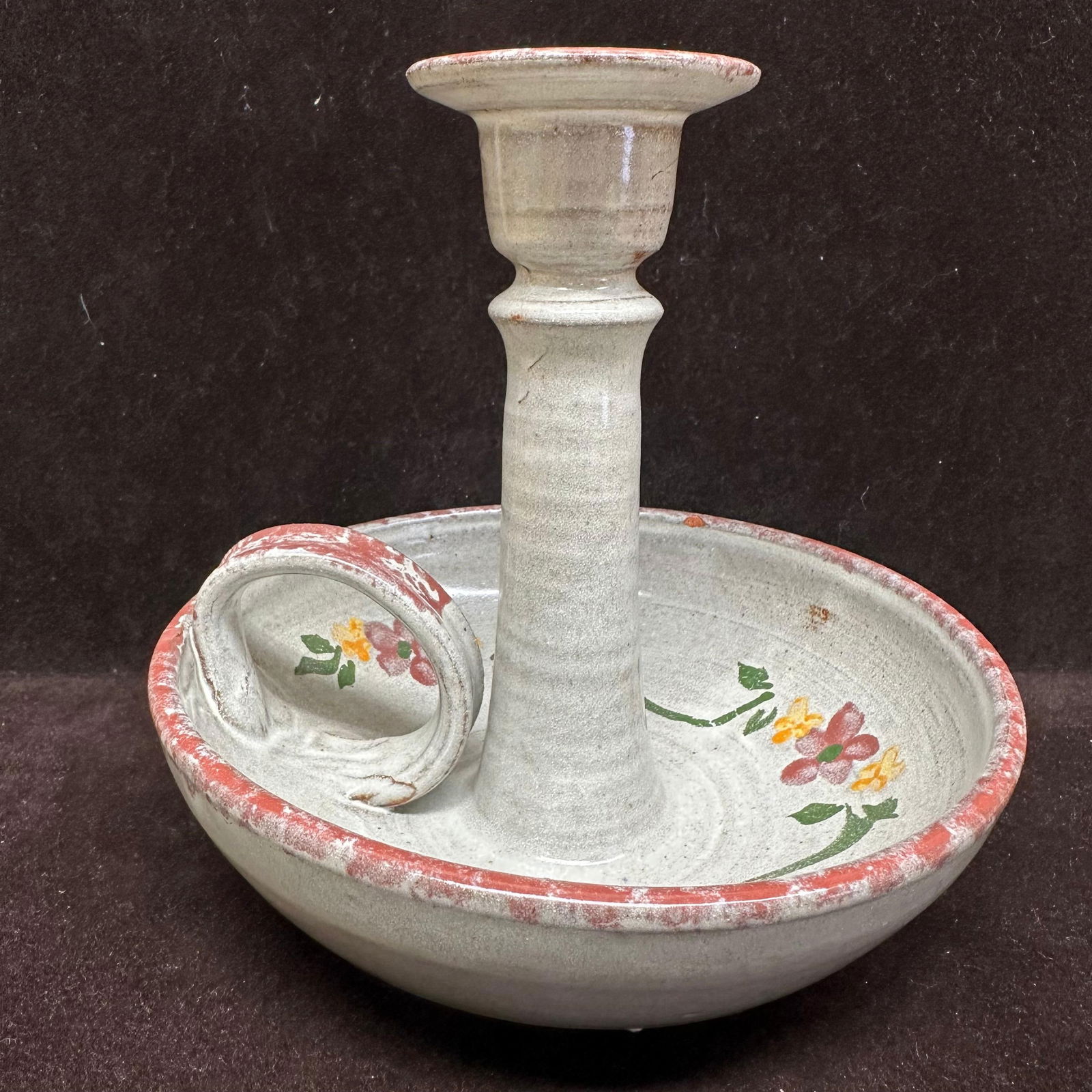 Owens Pottery Floral Candleholder Wax Catching Base: Vintage Owens Pottery ceramic chamberstick candleholder with attached match holder. Finished in matte gray glaze with hand-painted floral decoration and red banded rim. Circular drip tray with