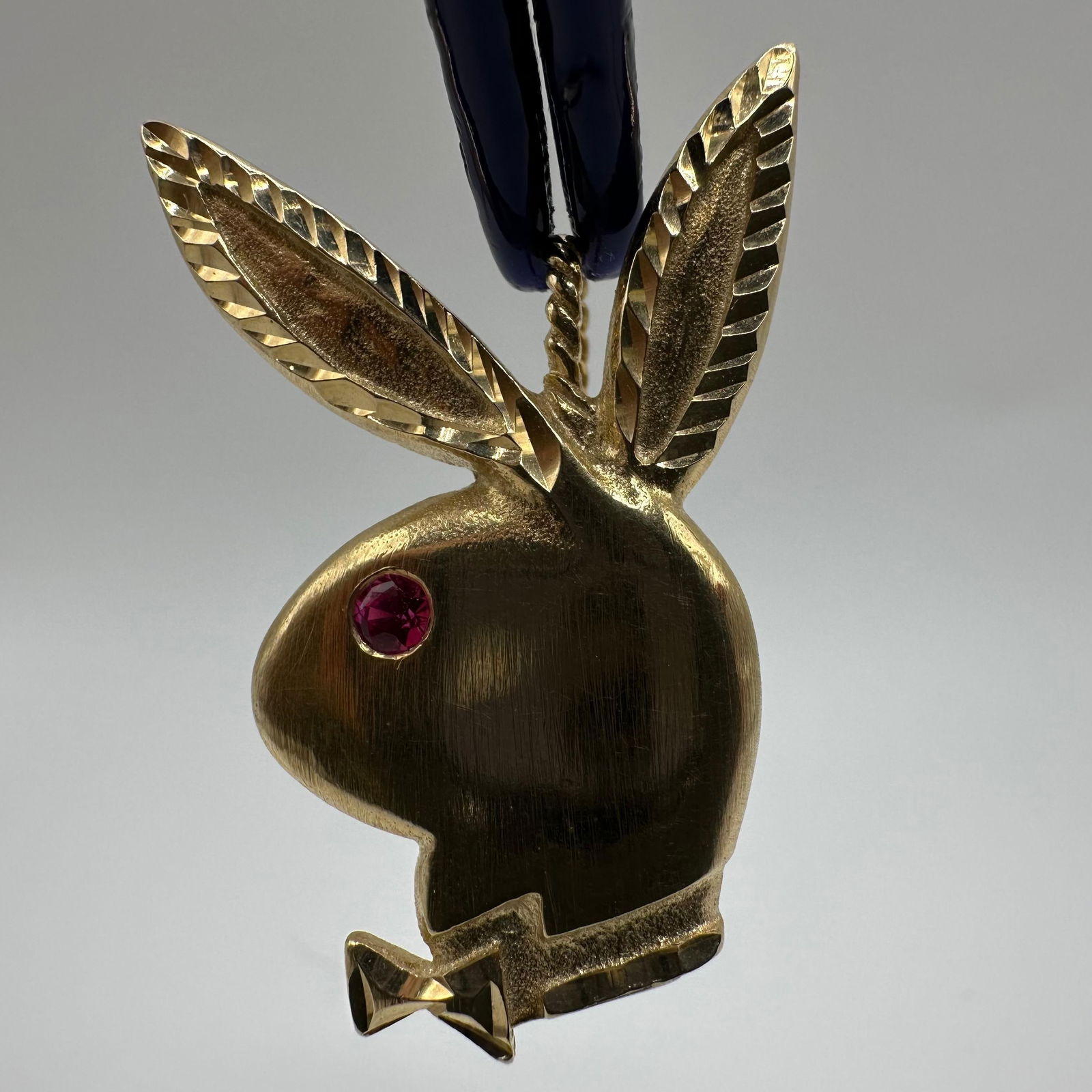 Michael Anthony 14k Yellow Gold Playboy Bunny Ruby Pendant: This item is in good pre-owned, previously used/displayed condition with noticeable light wear and surface scratches. Please reference all photos for full details. This piece of jewelry has been teste