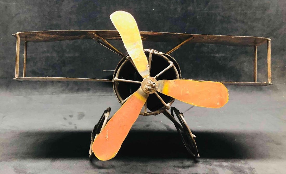 Large Vintage Metal Plane Figurine: This lot contains a Large Vintage Metal Plane Figurine. It is approx 22" x 19 1/4" x 10" and it weighs about 5.7lbs. Overall the Plane Figurine is in good used condition with some light wear from use