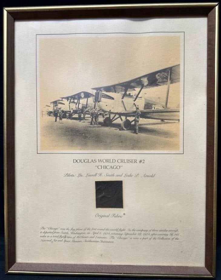 Douglas World Cruiser Chicago Cloth Display: Douglas World Cruiser Chicago Cloth Display Framed display with a piece of actual cloth from the Douglas World Cruiser #2 "Chicago". The display includes a photograph of the famous plane, one