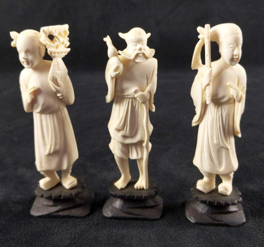 White Resin 3 Figurines Xiangzi Nezha Zhong Kui: This lot includes these white resin figurines on black vases: (1)Han Xiangzi, the patron deity of flutists. This is approx 1 1/2" x 1" x 5". (1) Nezha, patron saint of young adults. This
