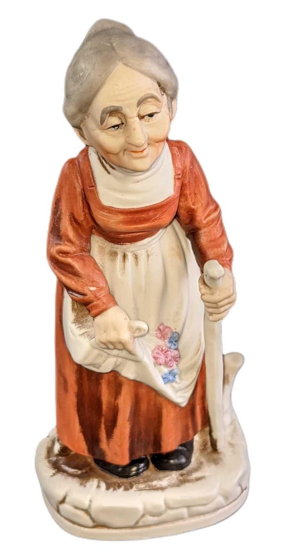 Vintage Porcelain Bisque Old Woman With Cane Figurine: Vintage Porcelain Bisque Old Woman With Cane Figurine. The maker and date of creation are unknown. The figurine is approx 4" x 3" x 8" and it weighs under one pound at 0.76lb. The figurine is in a goo