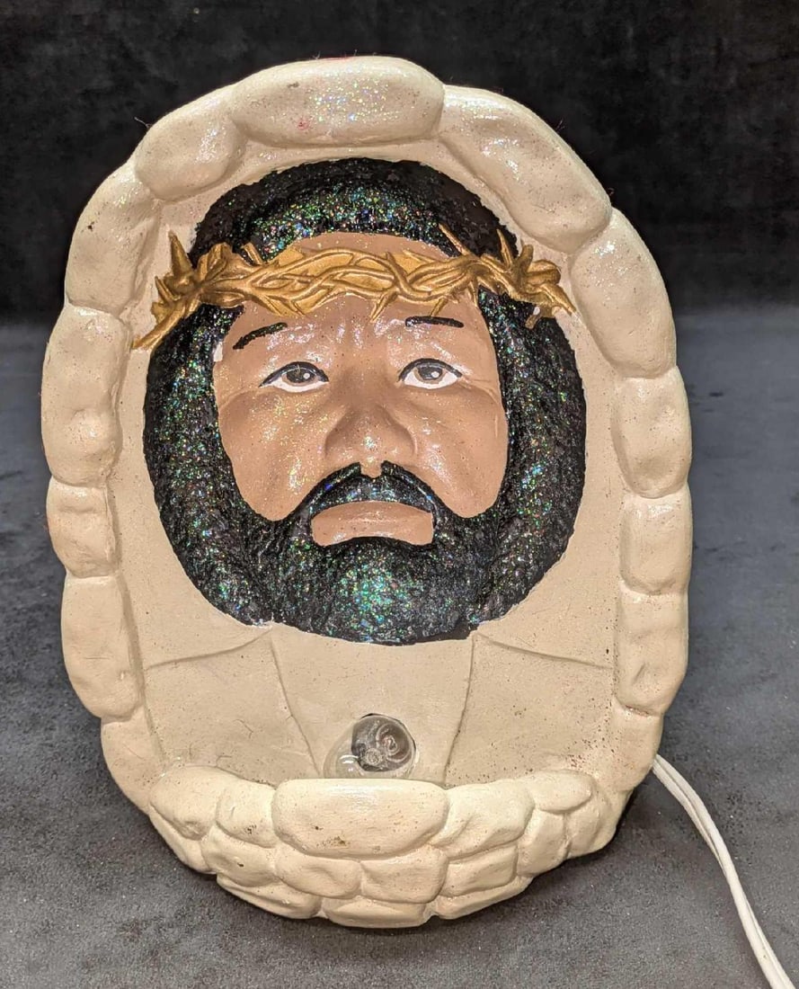 Light Up 3D Black Jesus Display: Light Up Black Jesus Display. Appears to be made of a plaster. This is approx 7" x 5" x 9" and it weighs 1.70lbs. Has some markings and a small chip on the left side of the display. Light was tested