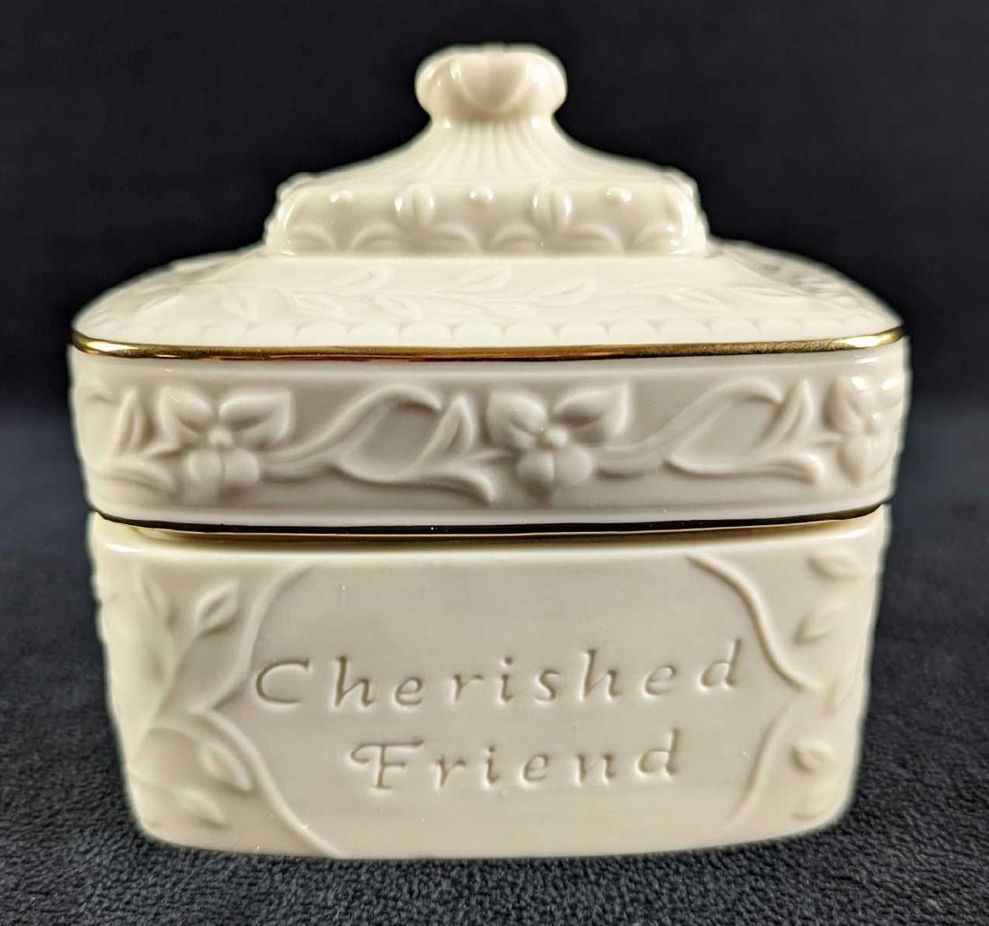 Lenox Sentiment Cherished Friend Music Trinket Box: Lenox Sentiment Cherished Friend Music Box. It played Scott Joplin's "The Entertainer". This two piece ivory/cream porcelain trinket music box with gold trim is approx 4" x 2 1/2" x 4". It