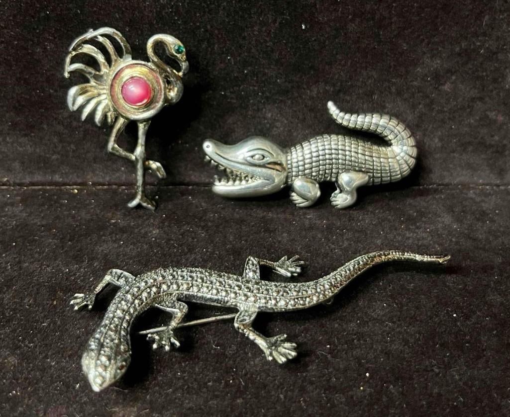 Silver Tone Alligator Lizard And Flamingo Brooch Bundle: This lot contains a Silver Tone Alligator Lizard And Flamingo Brooch Bundle. The lizard brooch is approx 3 1/4" x 1 1/2" x 1/4". The alligator is approx 2 1/4" x 1 1/4" x 1/2". The flamingo is approx