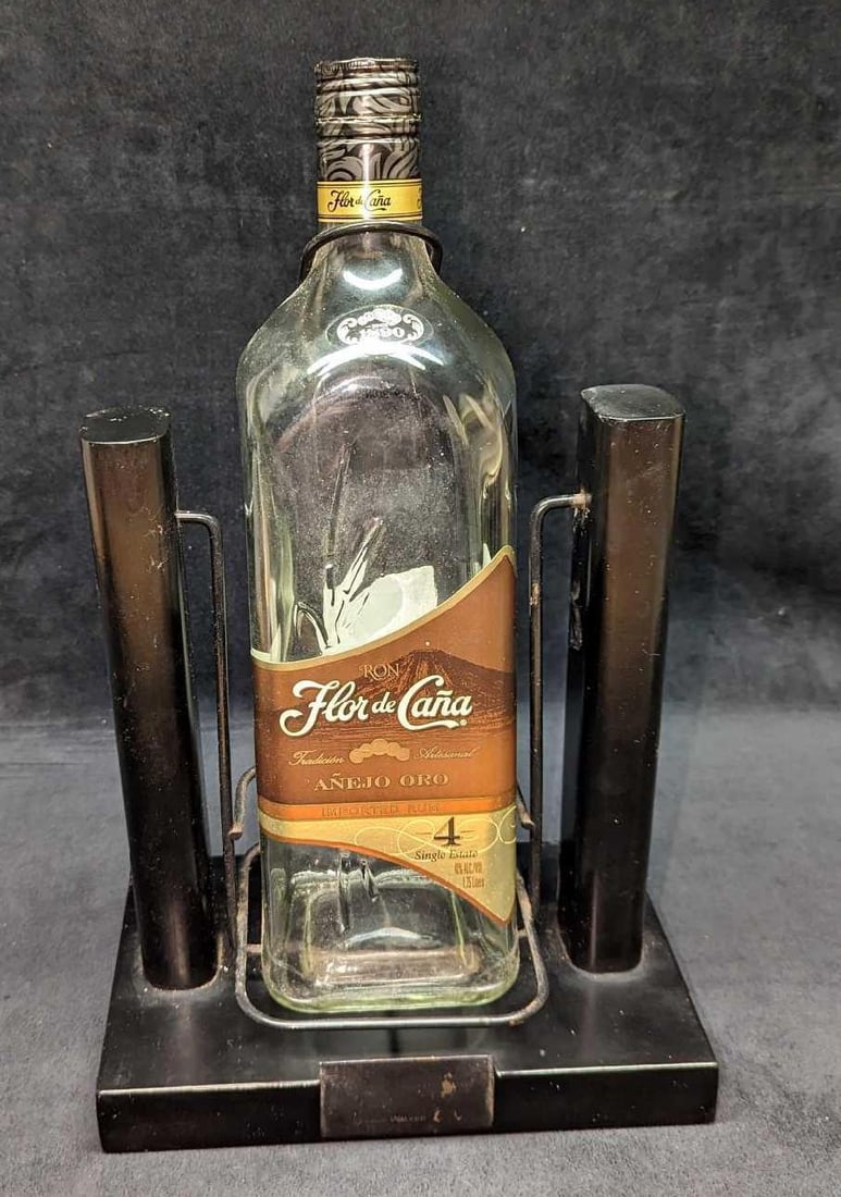 Johnnie Walker Wooden Black Bottle Cradle Stand: Johnnie Walker Wooden Black Bottle Cradle Stand. This is approx 9 1/2" x 5 7/8" x 13 3/4" and it weighs 5.39lbs. . It can hold a bottle that is approx 3 7/8" x 3 3/4" x 13". It is currently holding an