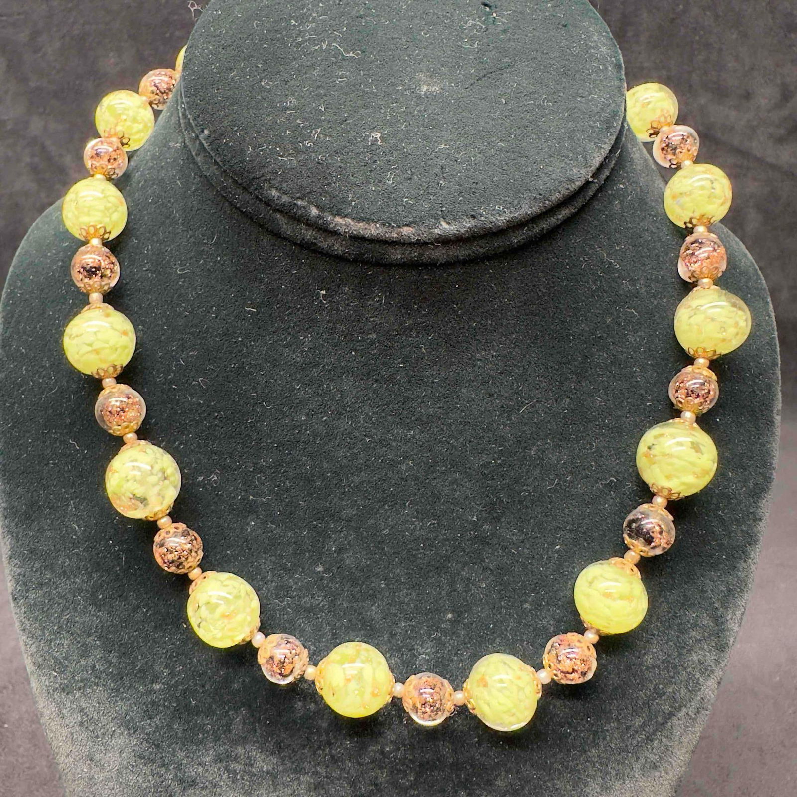 Venetian Murano Glass Lamp Work Light Green Round Copper Accents Beaded Necklace B12: Venetian Murano Glass Lamp Work Light Green Round Copper Accents Beaded Necklace B12. Necklace with light green glass beads with beautiful designs on each. The necklace features copper colored