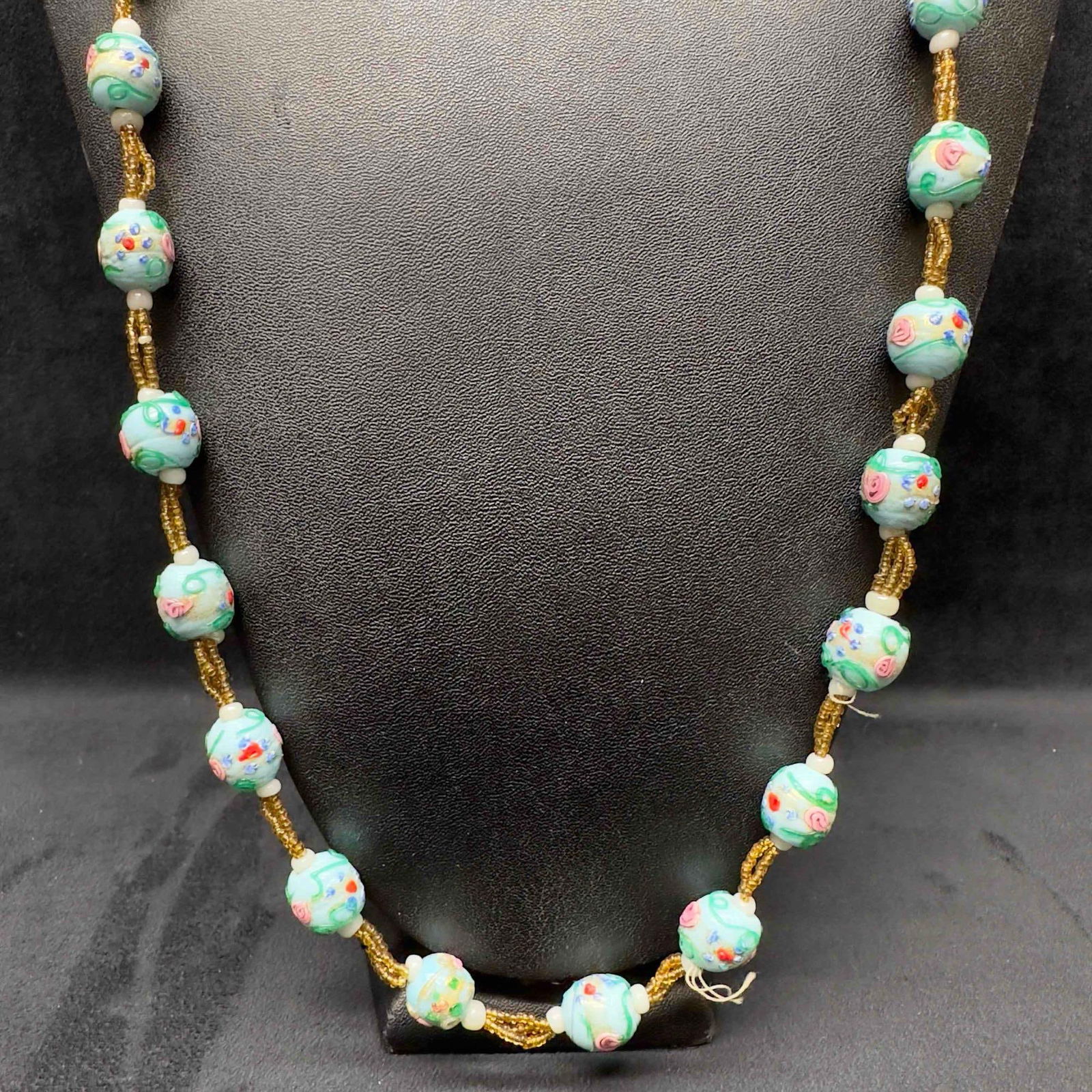Venetian Murano Art Glass Lamp Work Light Blue Floral Yellow Beaded Necklace D15: Venetian Murano Art Glass Lamp Work Light Blue Floral Yellow Beaded Necklace D15. Necklace with light blue colored glass beads with beautiful designs on each. The necklace features floral accents. Loo