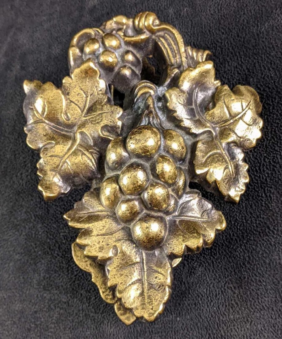 Brass Antique Reproduction Victorian Grape Knocker: Brass Antique Reproduction Victorian Grape Knocker This is a charming door knocker that is made from solid brass with a dark and shiny patina on it. There is not much more of a Victorian motif than th