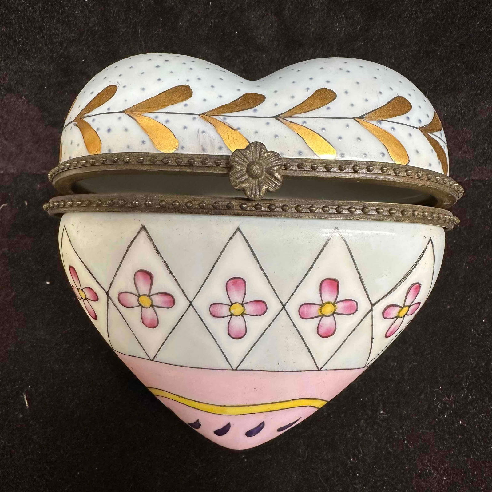 Vintage CBK Ltd 1997 Porcelain Heart Trinket Box Hinged Floral Hand Painted: Vintage porcelain trinket box by CBK Ltd, dated 1997. Heart-shaped with hand-painted floral and geometric design in pink, gold, and blue accents. Hinged closure with decorative metal rim and flower cl