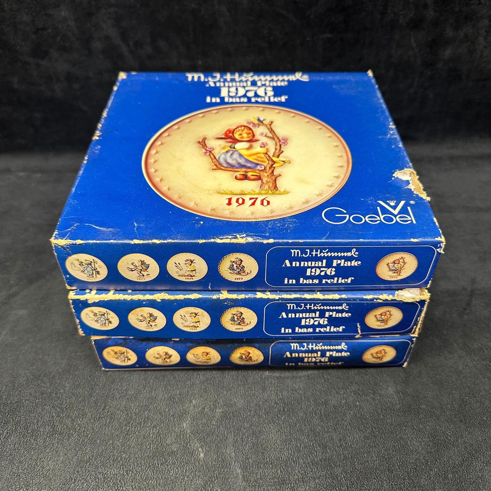 Lot of 3 Goebel M.J. Hummel 1976 Annual Collector Plates with Original Boxes: A lot of three (3) vintage M.J. Hummel annual collector plates by Goebel, West Germany. Each plate is the 1976 edition (6th Annual Plate, Hum 269), featuring a young girl sitting in a tree with a