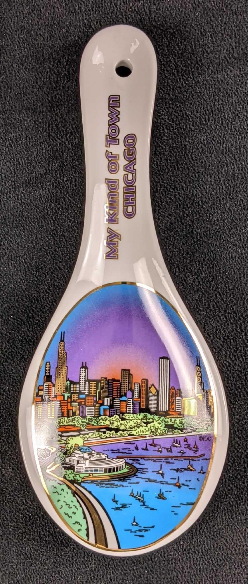Chicago My Kind Of Town Souvenir Porcelain Spoon: "My Kind Of Town" Chicago Souvenir Porcelain Spoon. Inspired by the Frank Sinatra Song, this large spoon has a colorful image of Chicago's skyline at the end. The spoon is approx 3 1/4" x 8 3/4"