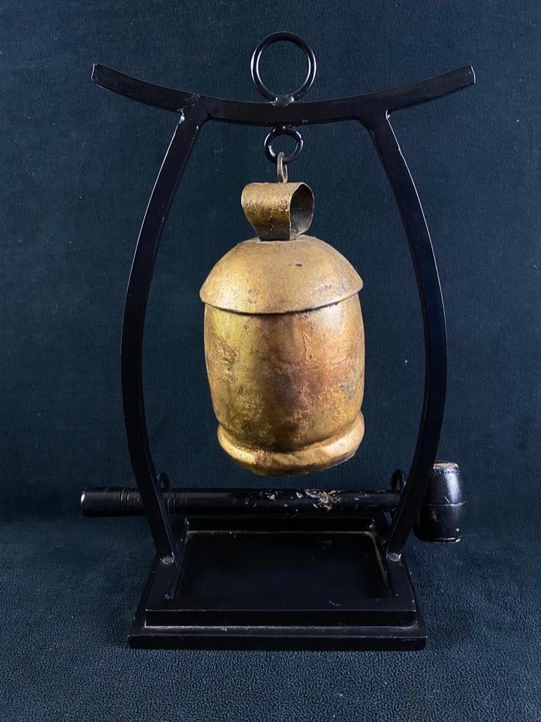 Decorative Temple Bell Made in India: Decorative Temple Bell Made in India Aluminum temple bell painted gold, in an iron frame with a wooden mallet. Great decor piece, with a rustic look. Wooden mallet is painted black, with some