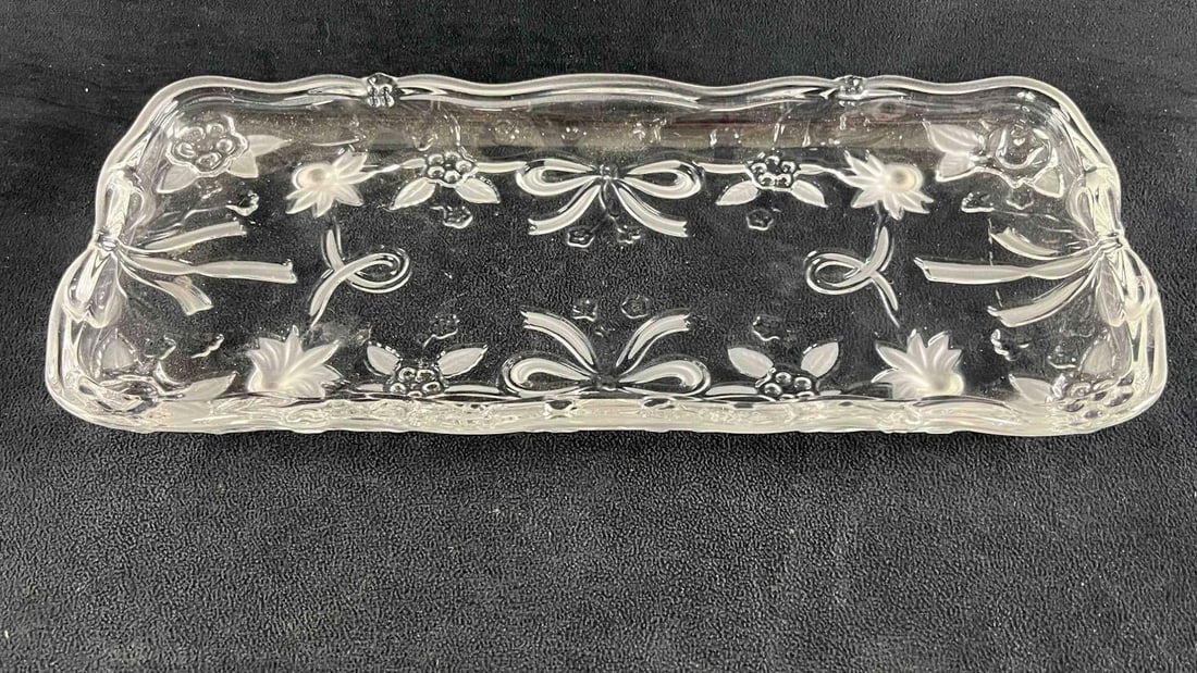 Christmas Holiday Rectangle Clear Glass Plate: Christmas Holiday Rectangle Clear Glass Plate This festive plate is made from clear glass with molded designs and different textures to make up the plates festive design. This small platter is in good