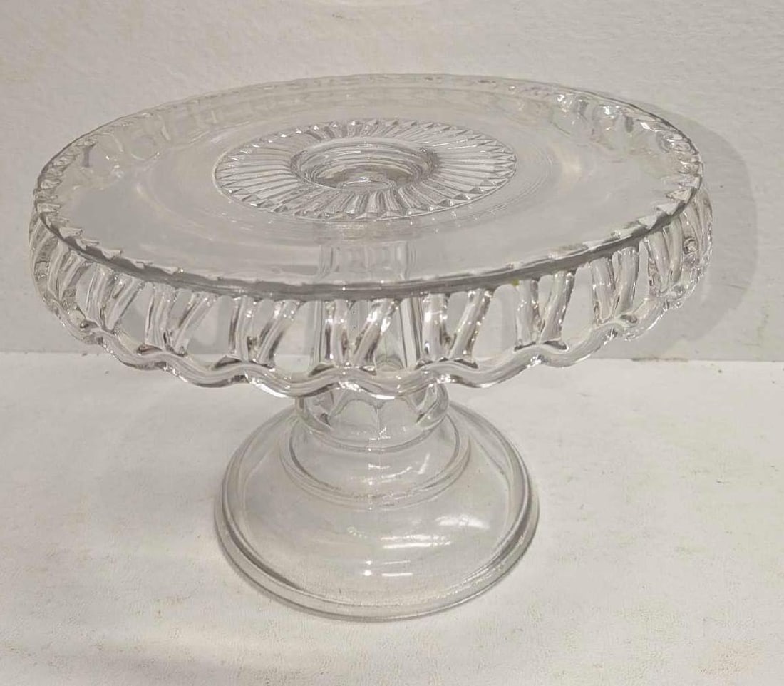 Vintage Clear Glass Pedestal Cake Stand: Vintage Clear Glass Pedestal Cake Stand. The maker and date of creation is unknown. The cake stand is approx 6" x 9" x 9" and it weighs 2.45lbs. The stand has some light scratches.