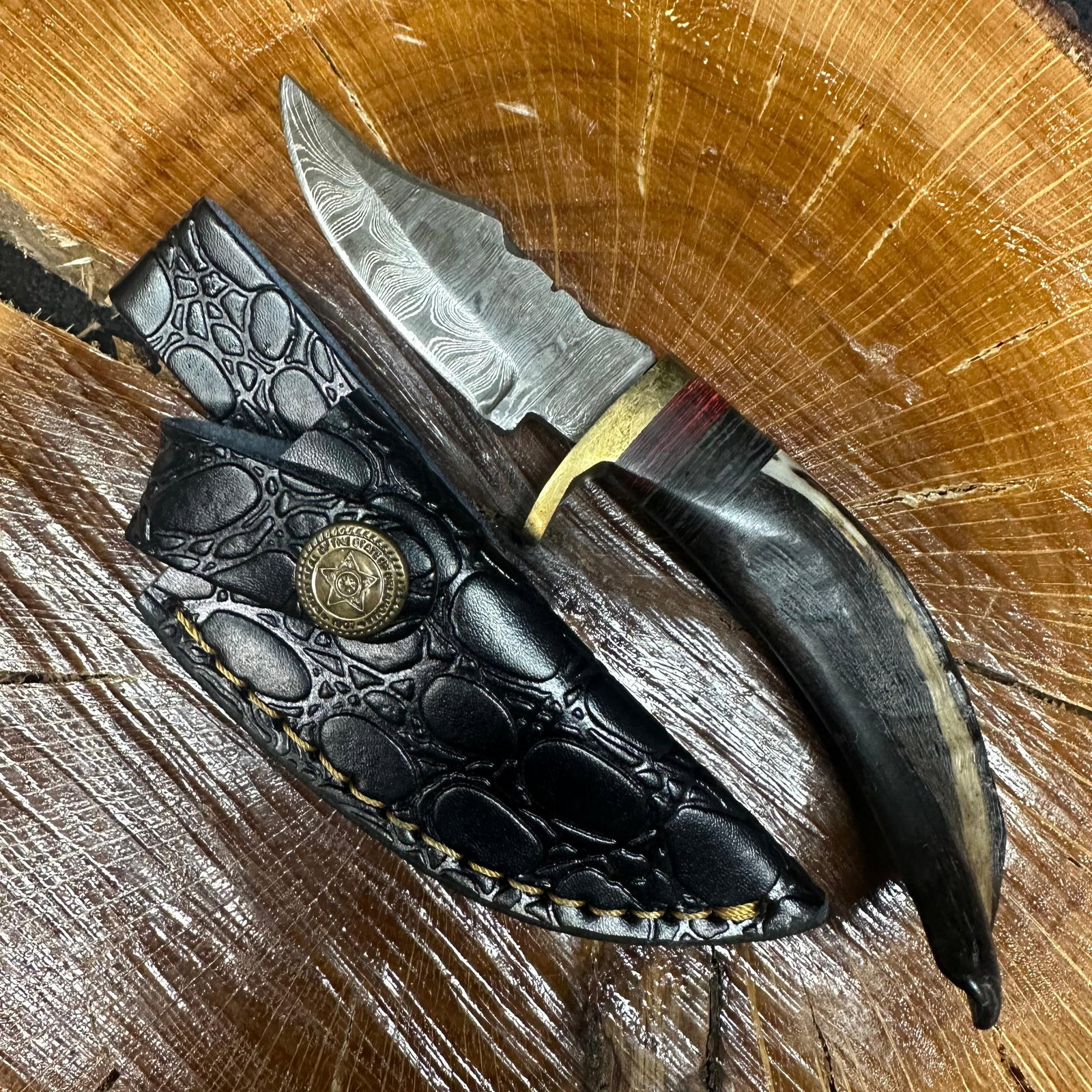 Small Fixed Blade Knife MHS Cutlery Horn Handle R28: Fixed small blade knife by MHS Cutlery featuring a textured steel blade and decorative spine work. The handle has a contoured, horn-style grip with metal mosaic accents. Includes a fitted black