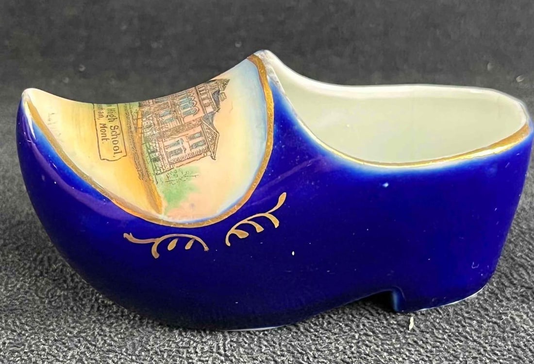 Vintage Porcelain German Clog: Vintage Porcelain German Clog This porcelain clog is blue with gold accents and has a painted school on the front. This item is in good condition with no known damage. 4in L x 1 1/2in W x 2in T 