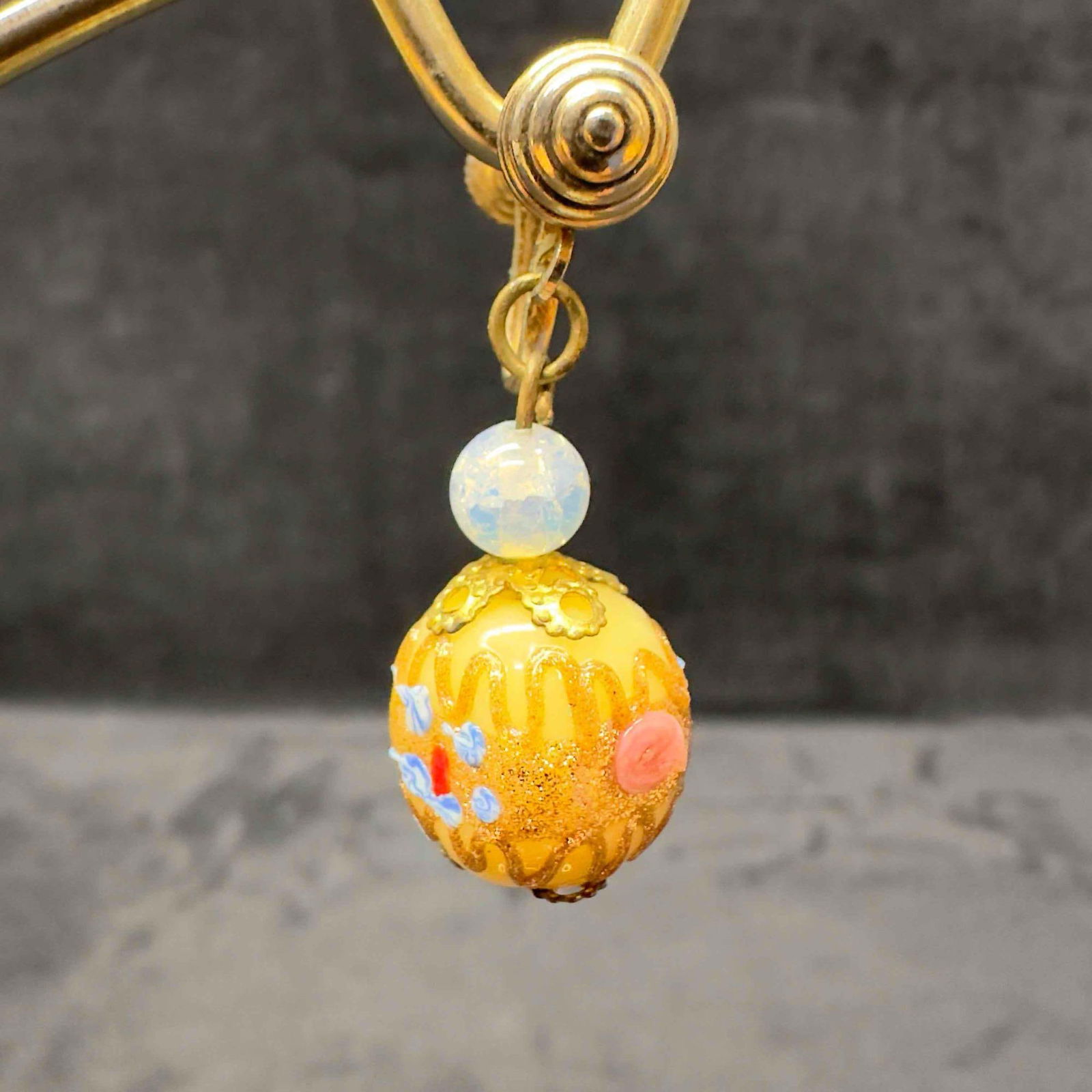 Murano Venetian Art Glass Lamp Work Cream Colored Floral Dangle Earrings G88: Murano Venetian Art Glass Lamp Work Cream Colored Floral Dangle Earrings G88. Earrings with cream colored glass beads with beautiful designs on each. The earrings feature copper colored accents. The e