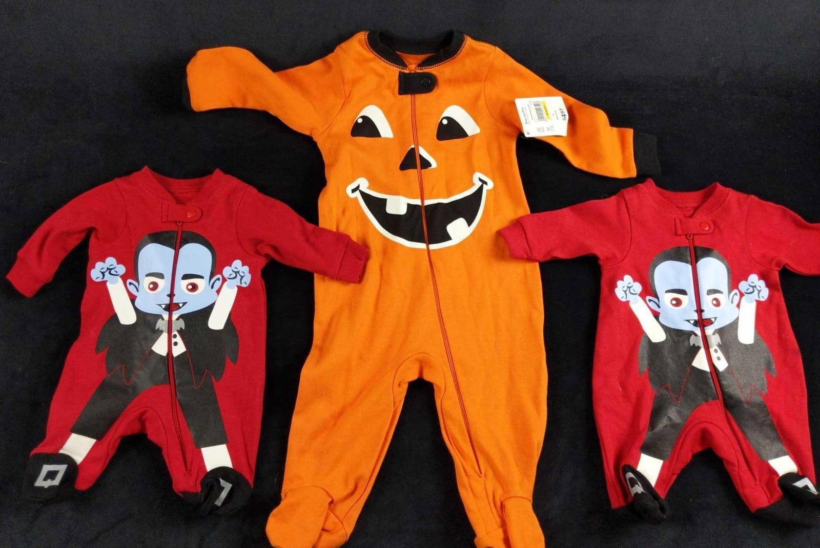 Baby Halloween Pajamas And Play Clothes Lot Of 3: This lot includes: (2) Vampire Preemie Pajamas. Made from 100% cotton. Zipper up with button clasp. Is approx 15" x 14". (1) Happy Jack O'Lantern. For 3-6 Months old. Made from 100% cotto