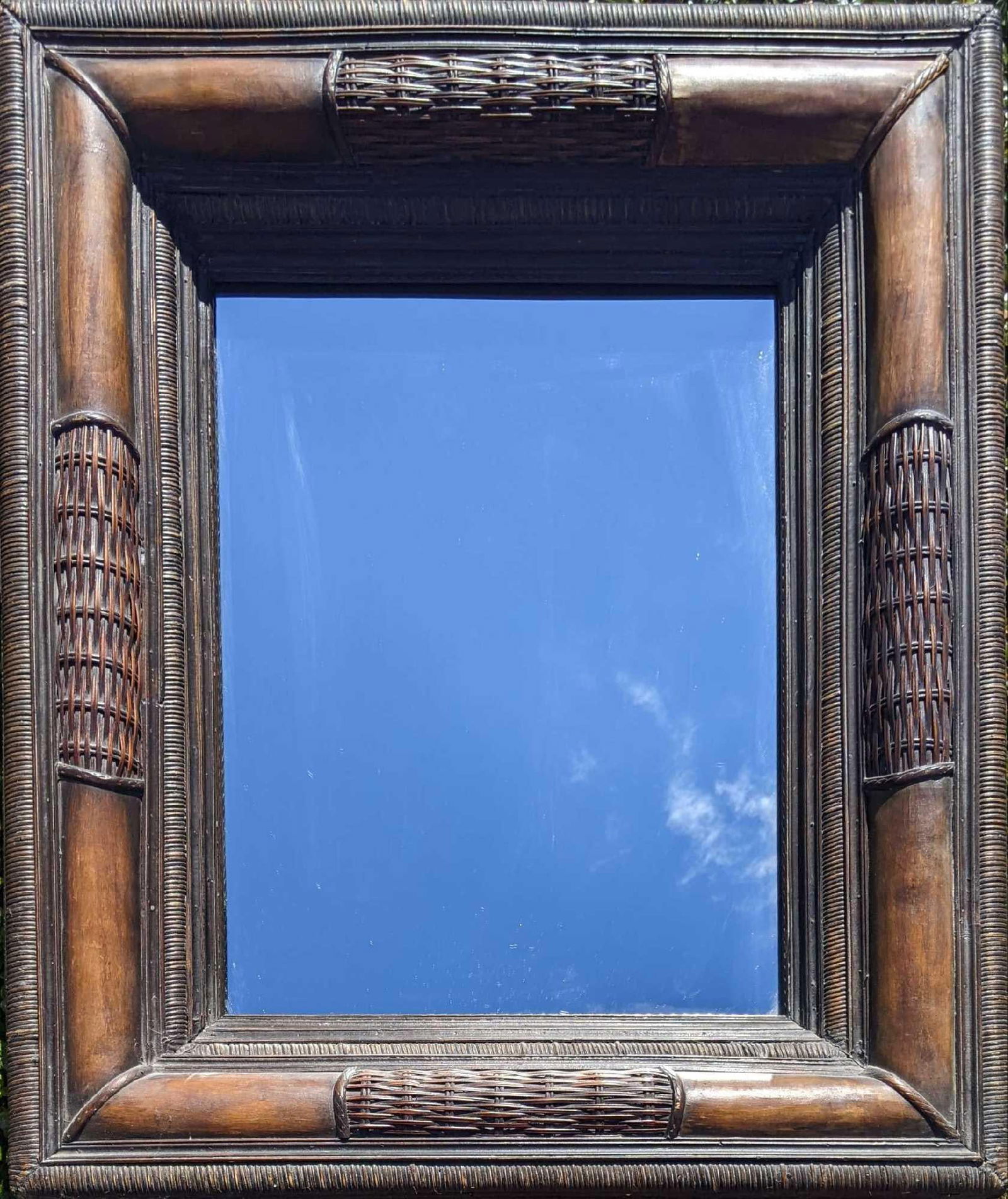 Decorative Mirror with Wicker Frame: Decorative Mirror with Whicker Frame This a is beautiful mirror in good condition with no known damage. It has a dark wicker/wooden frame. This is a large mirror but not a full-length mirror 33in x