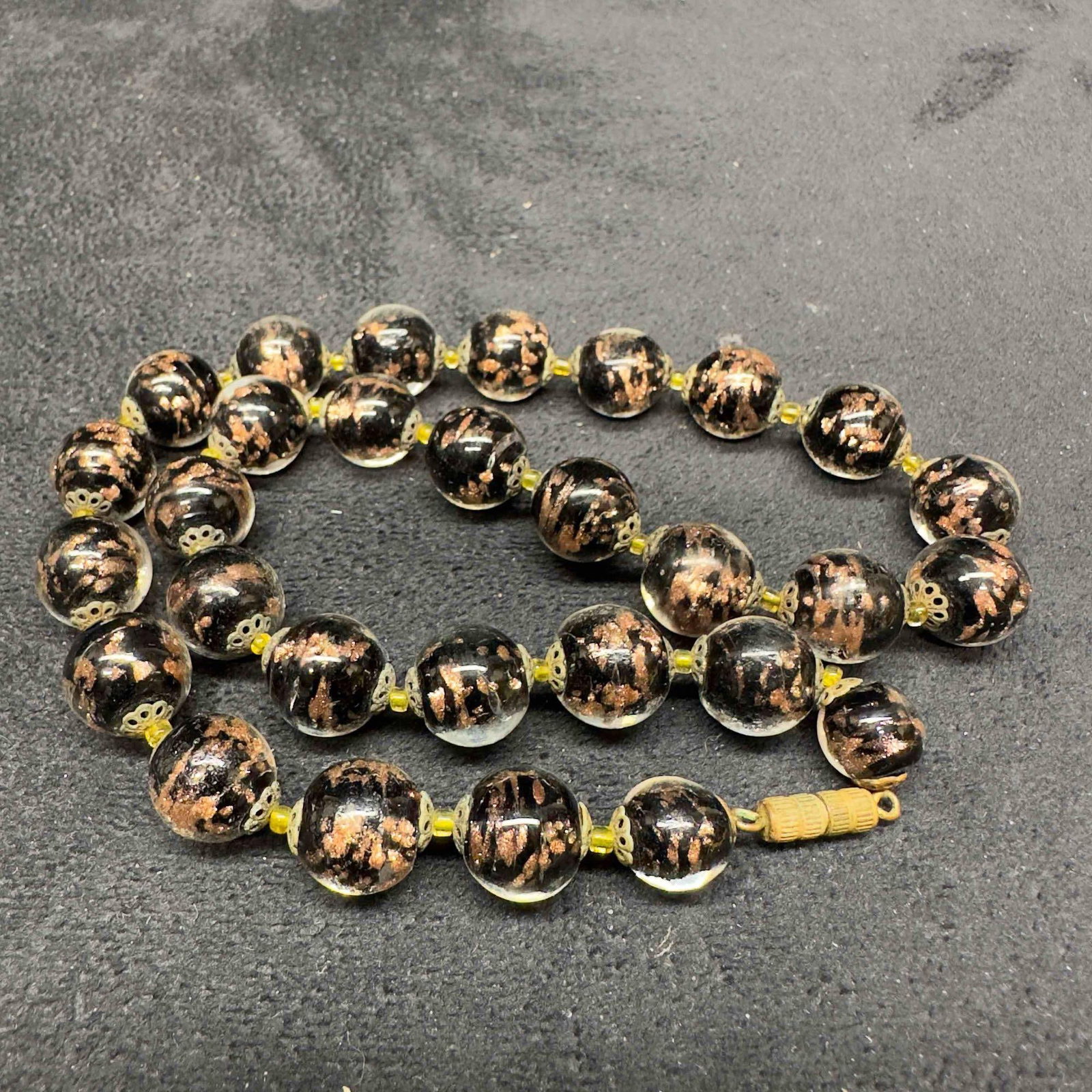 Murano Venetian Lamp Work Glass Copper Black Round Beaded Necklace B32: Murano Venetian Lamp Work Glass Copper Black Round Beaded Necklace B32. Necklace with black colored glass beads with beautiful designs on each. The necklace features copper accents. The necklace featu