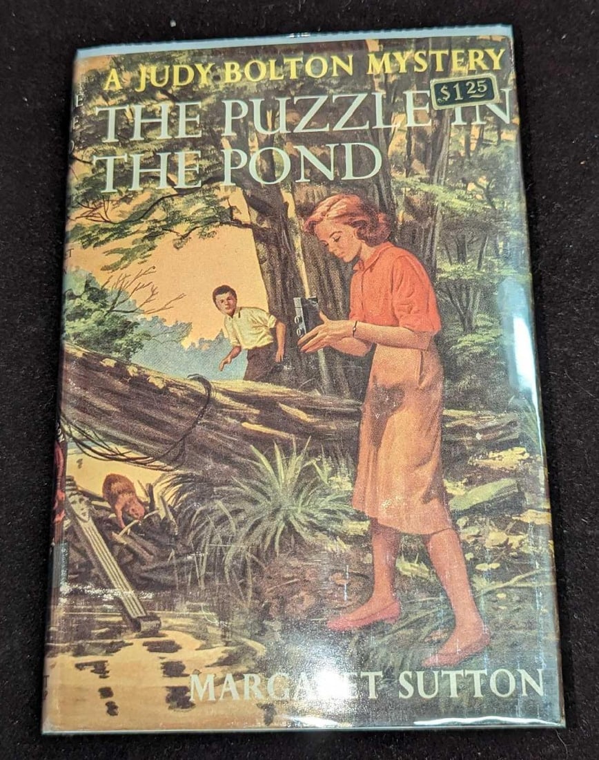 1st Ed Judy Bolton The Puzzle In The Pond #34: 1st Ed Judy Bolton The Puzzle In The Pond #34. "A Judy Bolton Mystery - The Puzzle In The Pond ". By Margaret Sutton (The pen name of Rachel Beebe) was published by Grosset & Dunlap (New York) and was