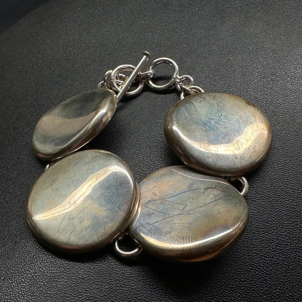 Sterling Large Flat Circle Link Bracelet: This piece of jewelry has been tested and researched prior to listing. Please view all our pictures they are part of our description. DETAILS: Metal - Sterling Silver Color - Silver Stones - none Hal