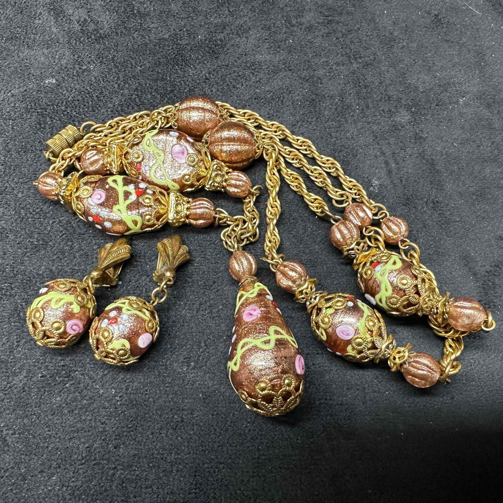 Art Glass Venetian Murano Lamp Work Copper Floral Painted Beads Gold Toned Earrings and Necklace Set: Venetian Murano Glass Lamp Work Bead Copper Floral Beaded Necklace and Earrings. Necklace with copper glass beads with beautiful floral designs on each. The necklace features a barrel clasp closure.