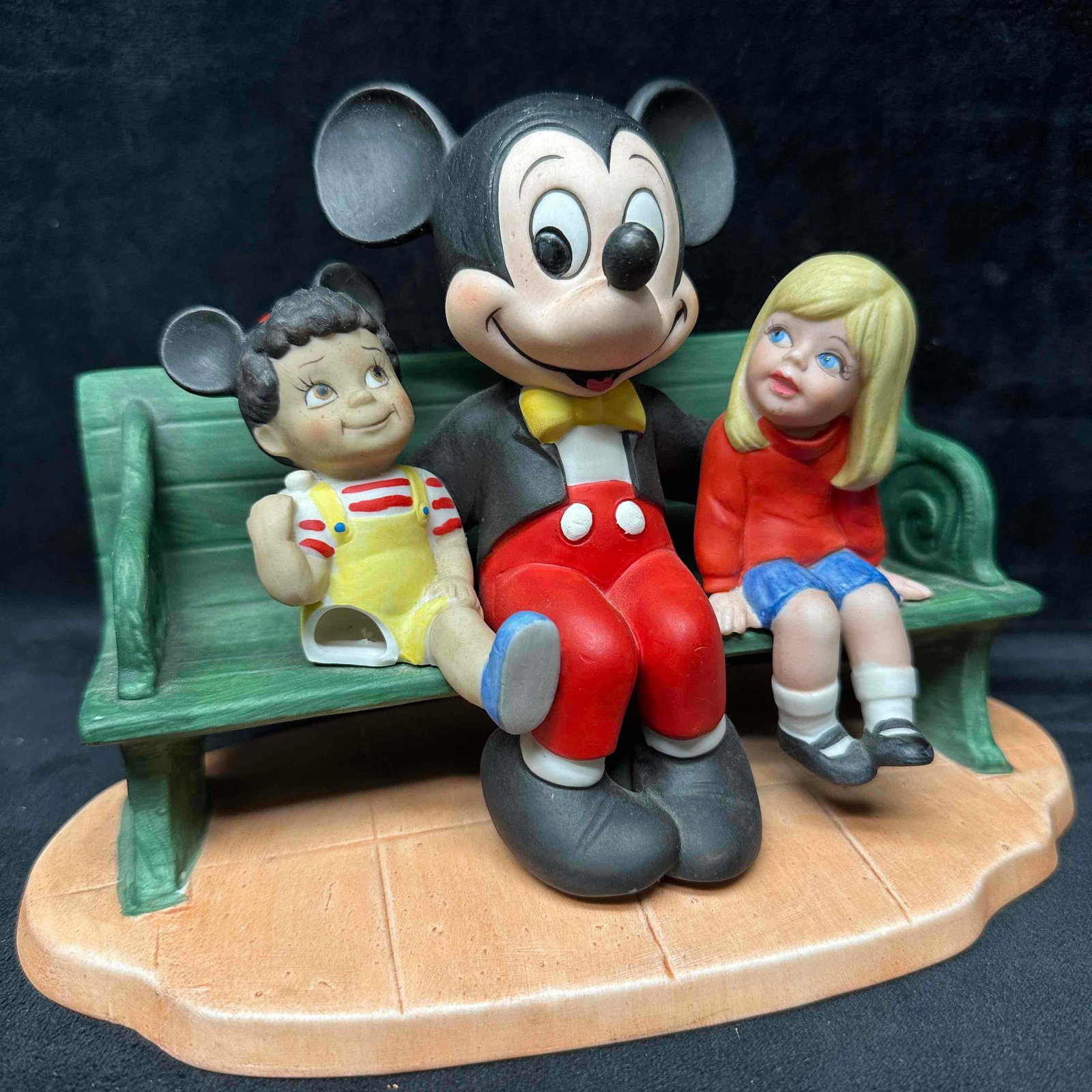 Disney Parks Mickey Mouse Figurine Porcelain Bisque Sitting On Bench With Kids: The little boy figure has a broken leg, piece missing. This item is in good pre-owned, previously displayed condition with minor wear, a small break in the porcelain, and surface scratches. Please ref