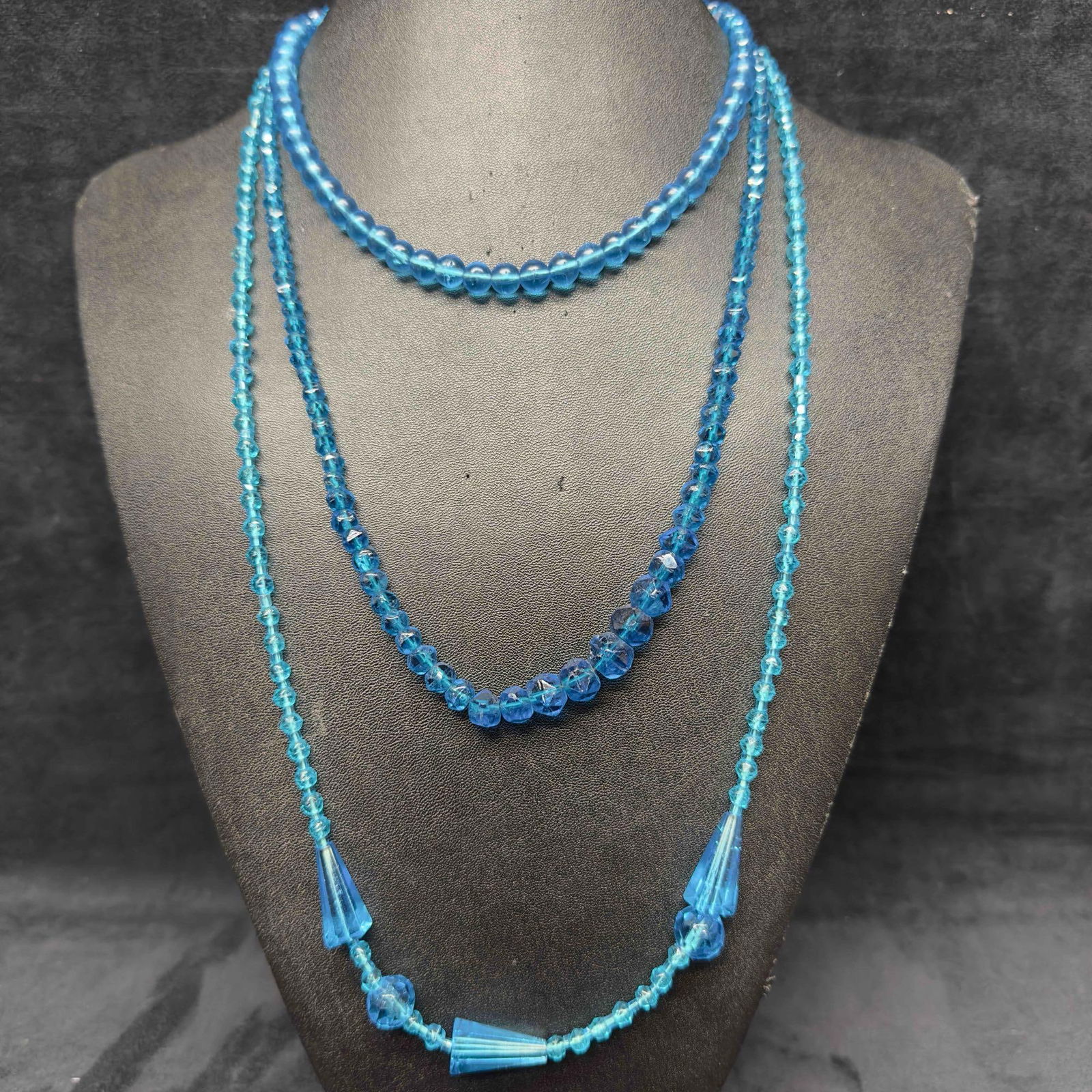 Clear Light Blue Glass Crystal Beaded Necklace Costume Jewelry Set Lot of Three Necklaces I27: Clear Light Blue Glass Crystal Beaded Necklace Costume Jewelry Set Lot of Three Necklaces I27. Necklaces with clear light blue crystal glass beads with beautiful designs. One necklace features a sprin