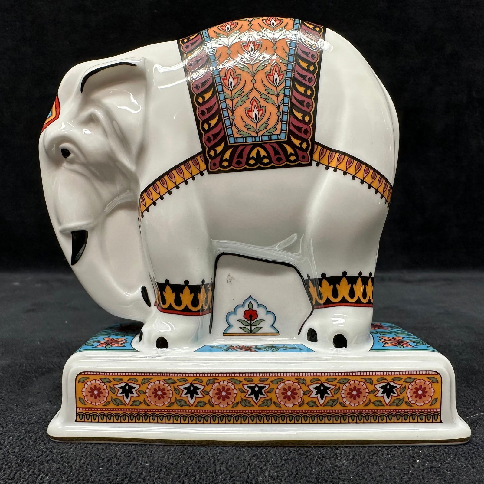 Wedgwood Noah’s Ark Collection Porcelain Elephant Figurine: Vintage Wedgwood porcelain elephant figurine from the Noah’s Ark Collection. Decorated in vibrant multicolor patterns with detailed floral and geometric accents. Includes the original Wedgwood blue