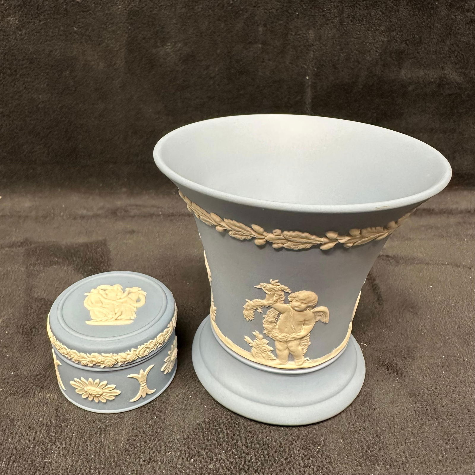 Pair of Wedgwood Jasperware Pieces Blue Vase and Trinket Box England: Pair of classic Wedgwood blue jasperware pottery pieces, made in England. This lot includes a flared vase and a small round trinket box, each featuring the signature matte light blue finish with