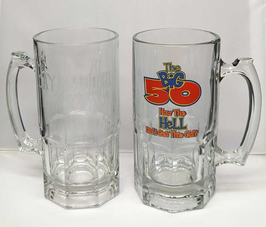 2 Big 50 & Baymeadows Golf Course Glass Beer Mugs: 2 Big 50 & Baymeadows Golf Course Glass Beer Mugs. This lot includes: (1) "The Big 50 How The Hell Did I Get This Old" Large Beer Mug. This is approx 6" x 4" x 8" and it