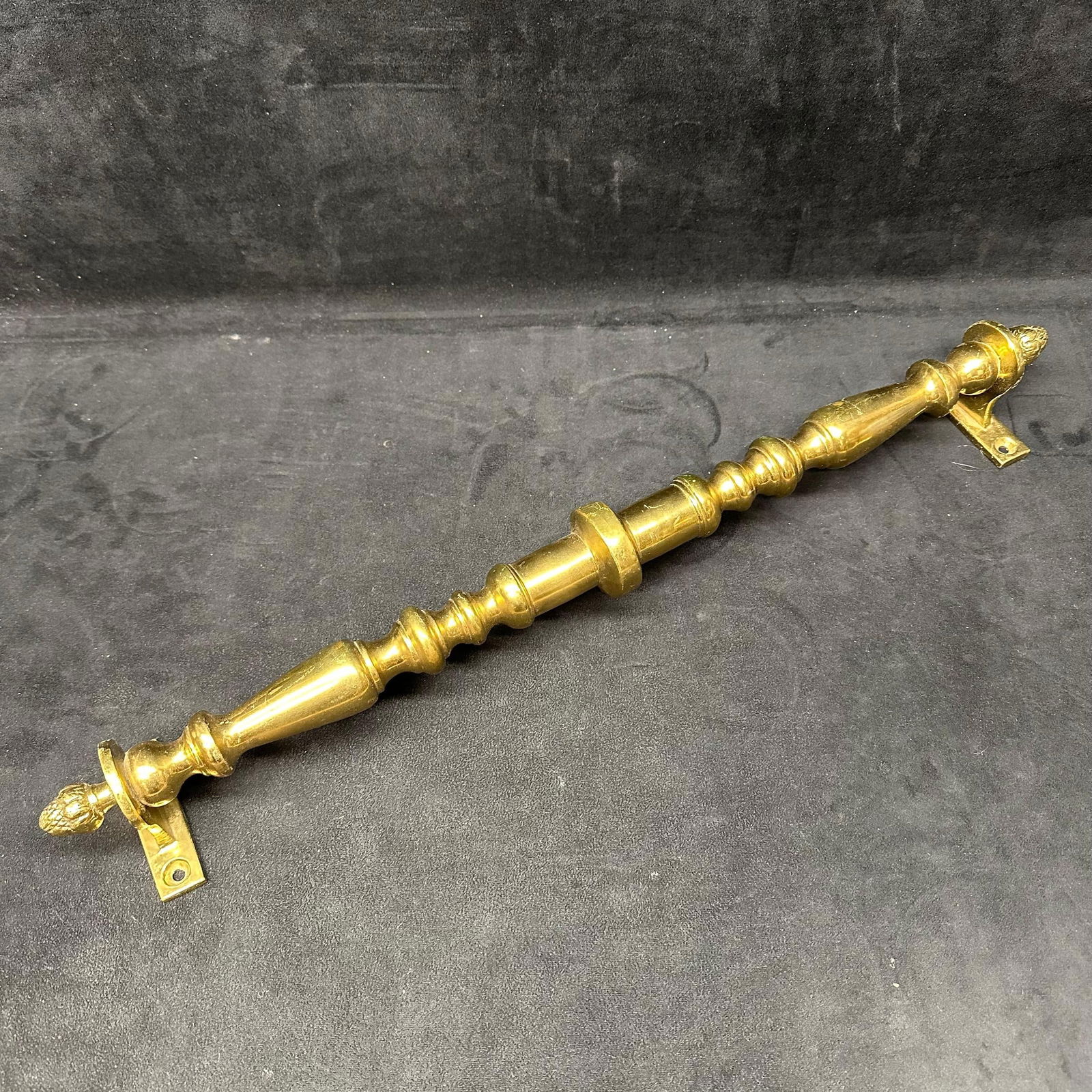 Antique Style Solid Brass Turned Architectural Pull Handle: Heavy solid brass architectural pull handle with turned baluster-form shaft and decorative acorn finials at both ends. Features rectangular mounting plates with pre-drilled screw holes. Polished brass