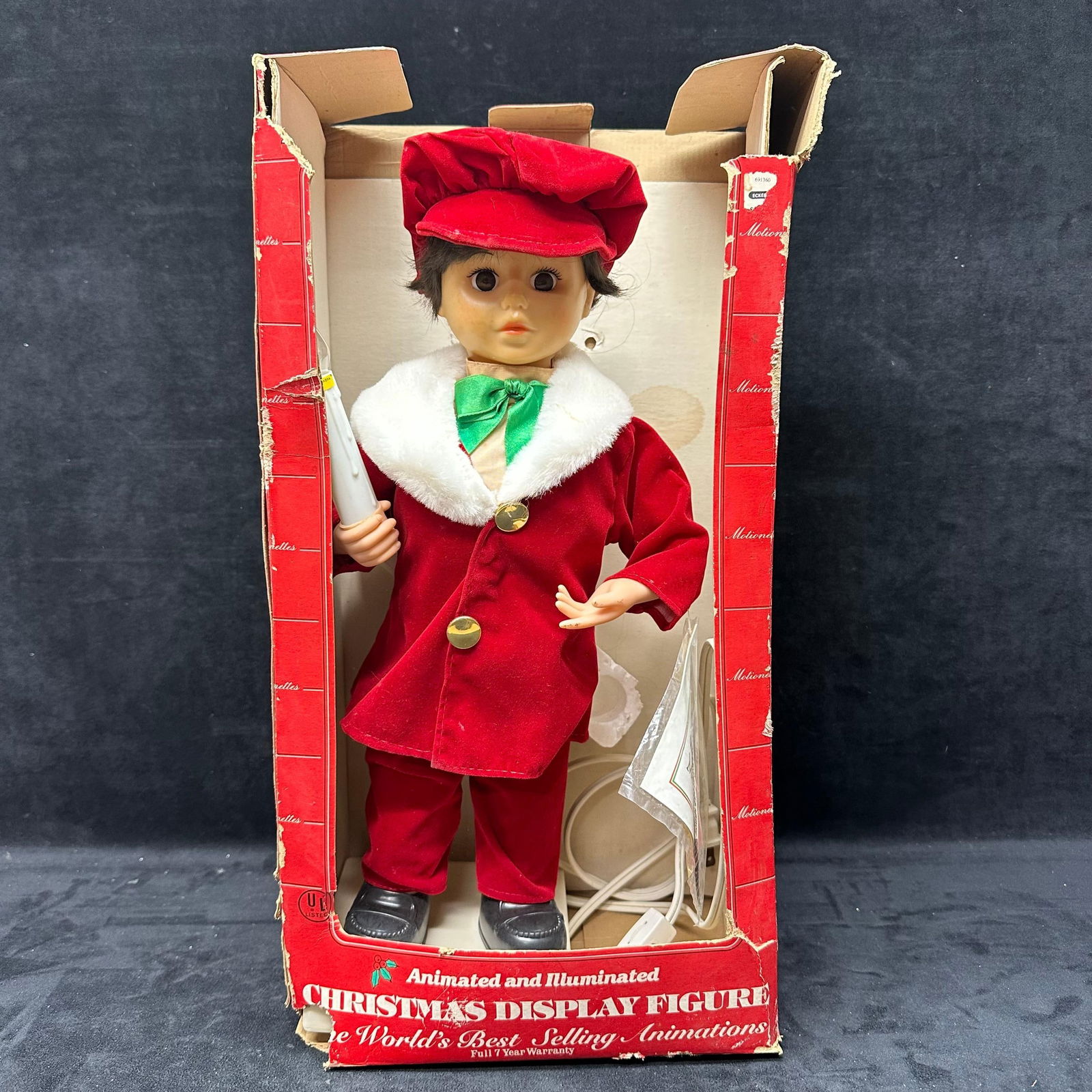 Telco Motion-ettes Animated and Illuminated Christmas Display Figure: Vintage Telco Motion-ettes of Christmas animated and illuminated display figure. Porcelite sculpted figure dressed in a red holiday outfit with white trim and green bow tie, holding a candle