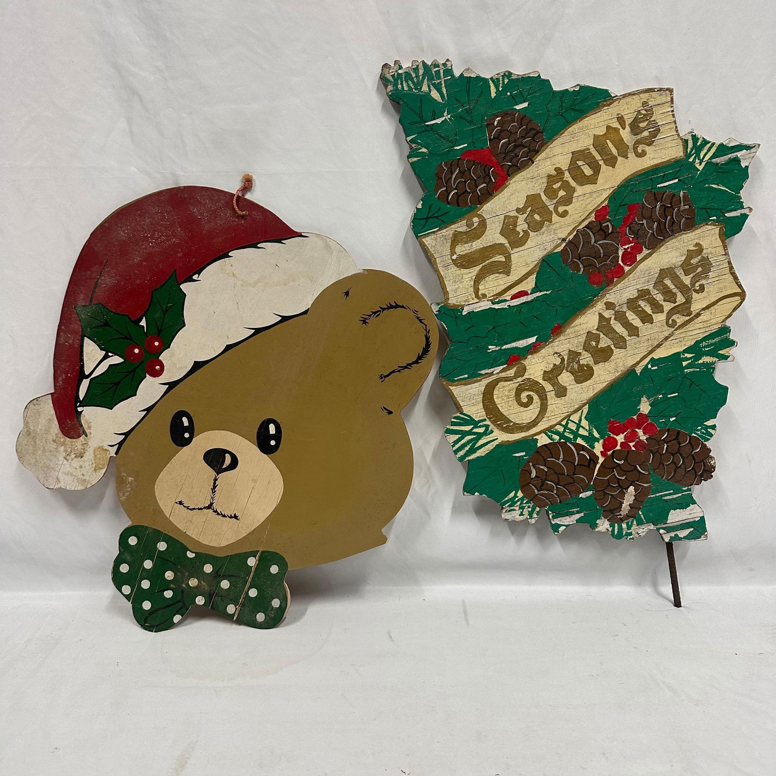 Wooden Christmas Decorations Teddy Bear Season Greetings Wood Signs: This lot includes a set of two vintage-style wooden Christmas decorations. Features a Teddy Bear wearing a Santa Hat and a holiday-themed Season Greetings wood sign. These items are in pre-owned,