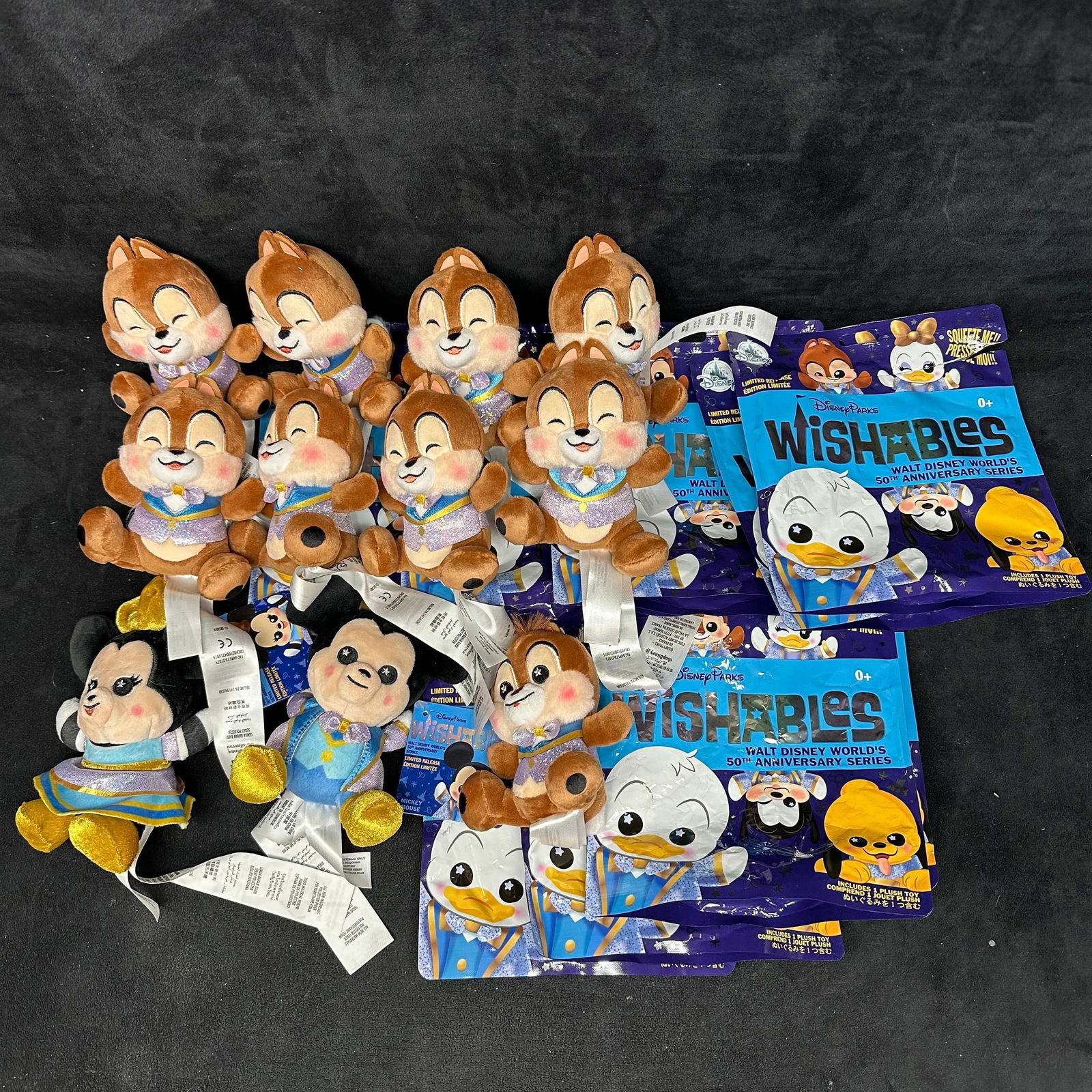 Assorted Disney Parks Wishables Plush Figures Walt Disney World 50th Anniversary Lot Chaser: A group of Disney Parks Wishables plush figures from the Walt Disney World 50th Anniversary series. Includes multiple character plush toys, primarily Chip Chaser Plush, with additional characters such