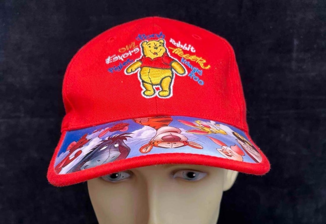 Walt Disney World Winnie The Pooh Youth Baseball Cap: This lot contains Walt Disney World Winnie The Pooh Youth Baseball Cap. It is approx 9" x 6 1/2" x 2 1/2". Total weight is 2.3 oz. Youth Size. Overall the baseball cap is in excellent pre owned condit