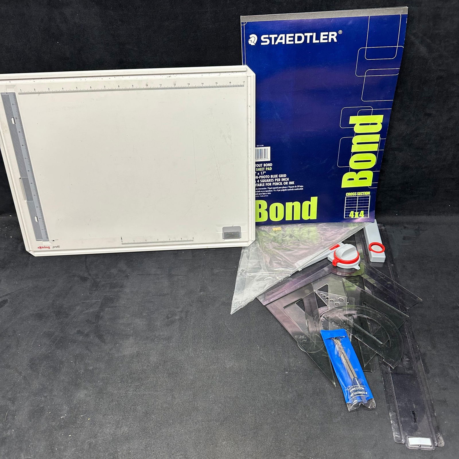 Rotring Profil Drawing Board Kit Rulers: Portable Rotring Profil drafting board with parallel straightedge and carrying case. Includes a variety of Staedtler drafting tools and supplies. The drafting board features a built-in measurement