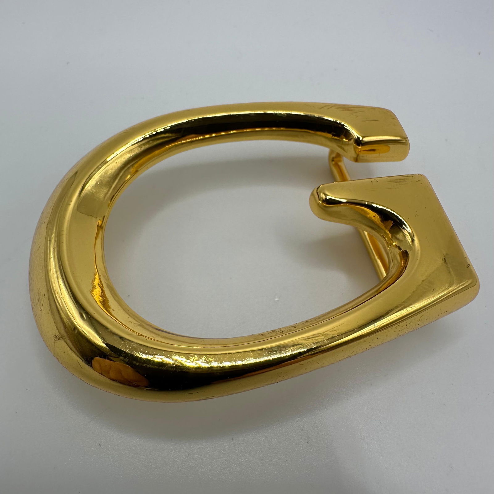 Guuci Italy G Gold Tone Belt Buckle G-Logo: The reverse is marked Gucci Italy. This item is in pre-owned, previously displayed condition with wear and surface scratches. Please reference all photos for full details. Size: 2 1/4" x 1