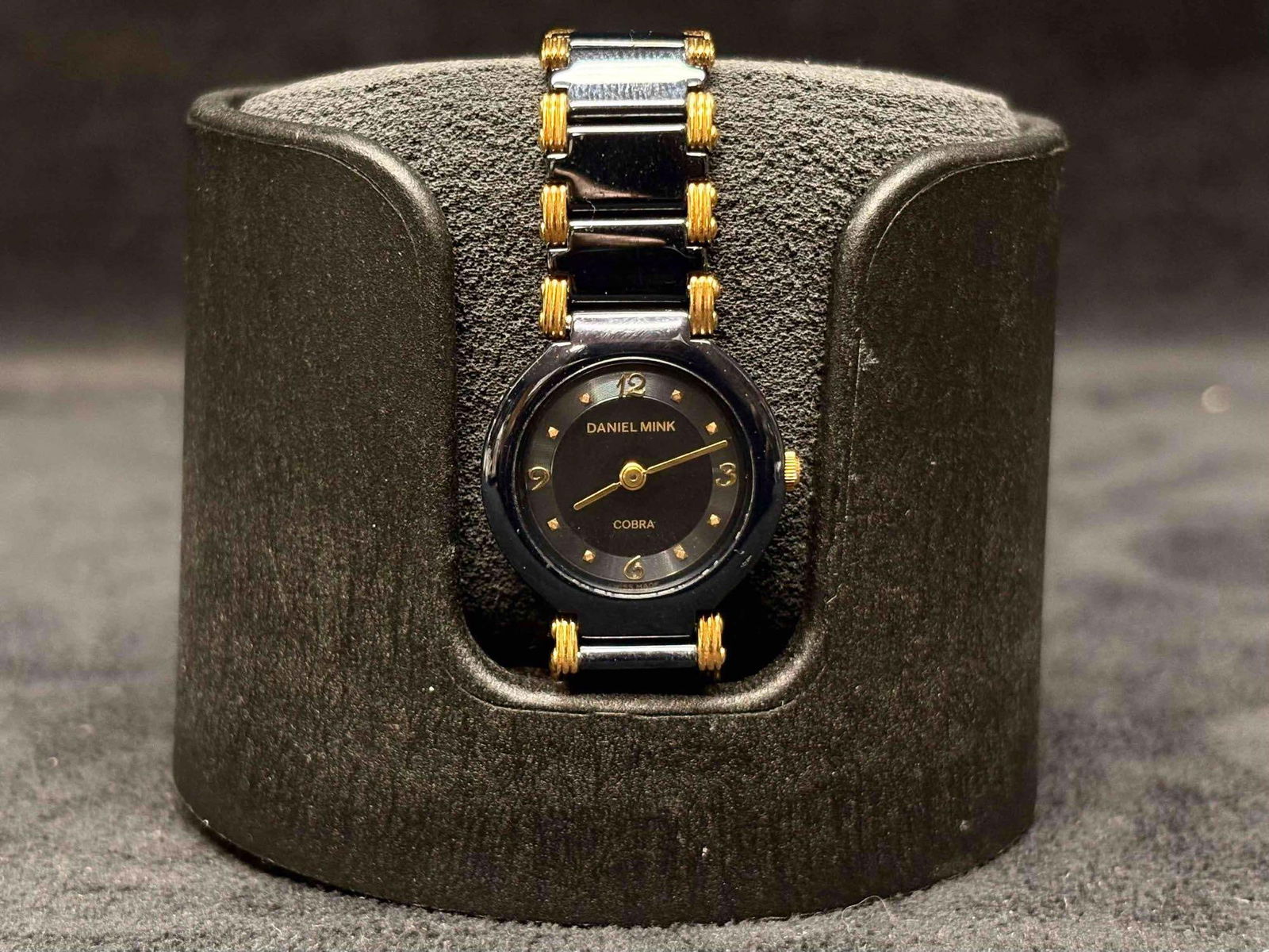 90s Vintage Daniel Mink Black and Gold Womens Watch and the Orbita Single Watch Holder Bundle: Purchased back in 1970s, this Daniel Mink Women's Watch has been kept tucked away in its matching velvet bag and box. This watch maintains its black and gold accent theme throughout, the Daniel