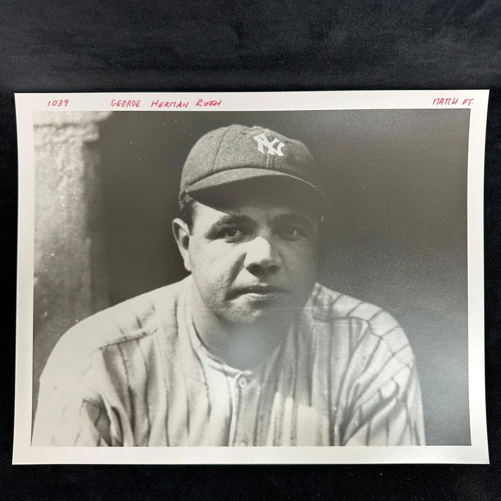 Babe Ruth Black and White Analog Photograph Print Portrait: Analog black and white photographic print depicting baseball legend George Herman "Babe" Ruth in his New York Yankees uniform. Close-up portrait highlights Ruth in cap and pinstripes, an iconi