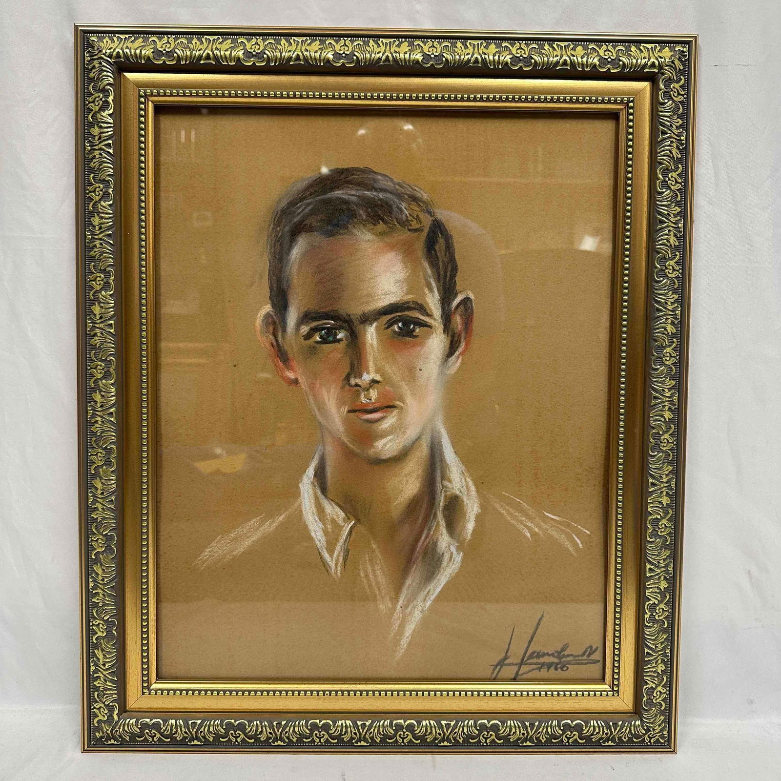 Portrait of a Young Man Pastel Drawing Framed Art R152: A framed pastel drawing dated and signed by unknown artist depicting a young man with short dark hair and a white collard shirt. The artwork, rendered on beige paper, captures a soft, introspective ex