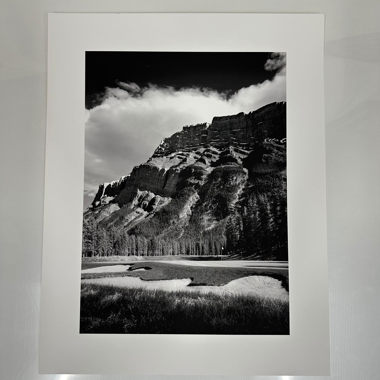 Black and White Landscape Photograph Print Mountain and Golf Course Scene Large Format A: Large format black and white photography print showing a dramatic mountain range rising above a golf course. The image features strong contrast, detailed texture, and balanced composition. Printed on