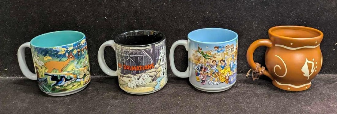Disney Character And 25th Anniversary Mugs: Disney Character And 25th Anniversary Mugs. This lot includes: (1) Walt Disney World 25th Anniversary Character Mug. Comes in the original mug that is approx 3 7/8". (1) 101 Dalmatians Pups Mug.