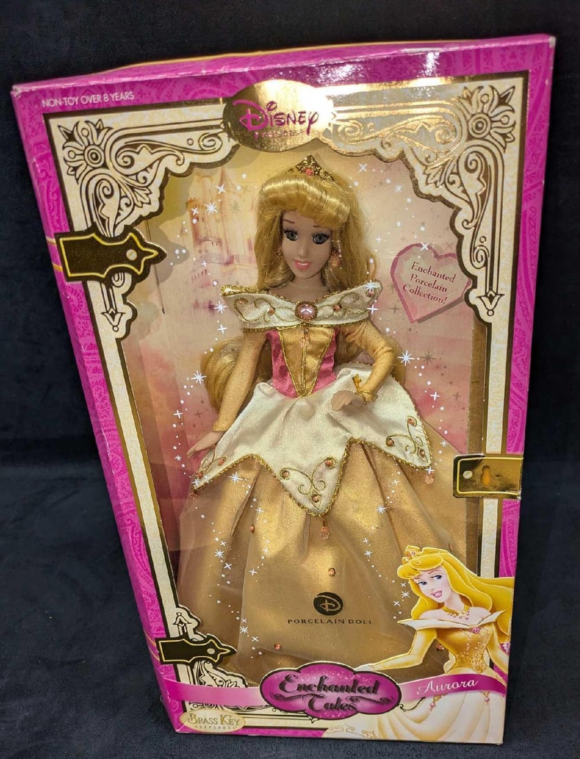 Disney Enchanted Tales Aurora Porcelain Doll NIB: Disney Enchanted Tales Aurora Porcelain Doll NIB. The doll comes in the original box that is approx 9 1/2" x 5" x 15 1/2" and it weigh 1.50lb. The doll has not been removed from the box. The box has s