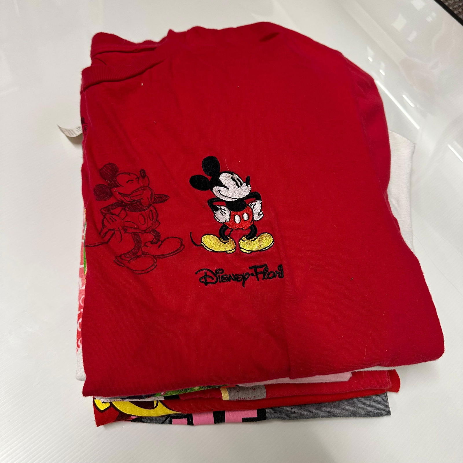 Variety Lot of Mickey Mouse Disney Tees Woman and Men T-Shirt Lot Eight: A variety of Disney family tees ranging from youth to adult men and women sizes. Pre-owned; light wear and fading consistent with normal use. These items are in pre-owned, previously displayed conditi