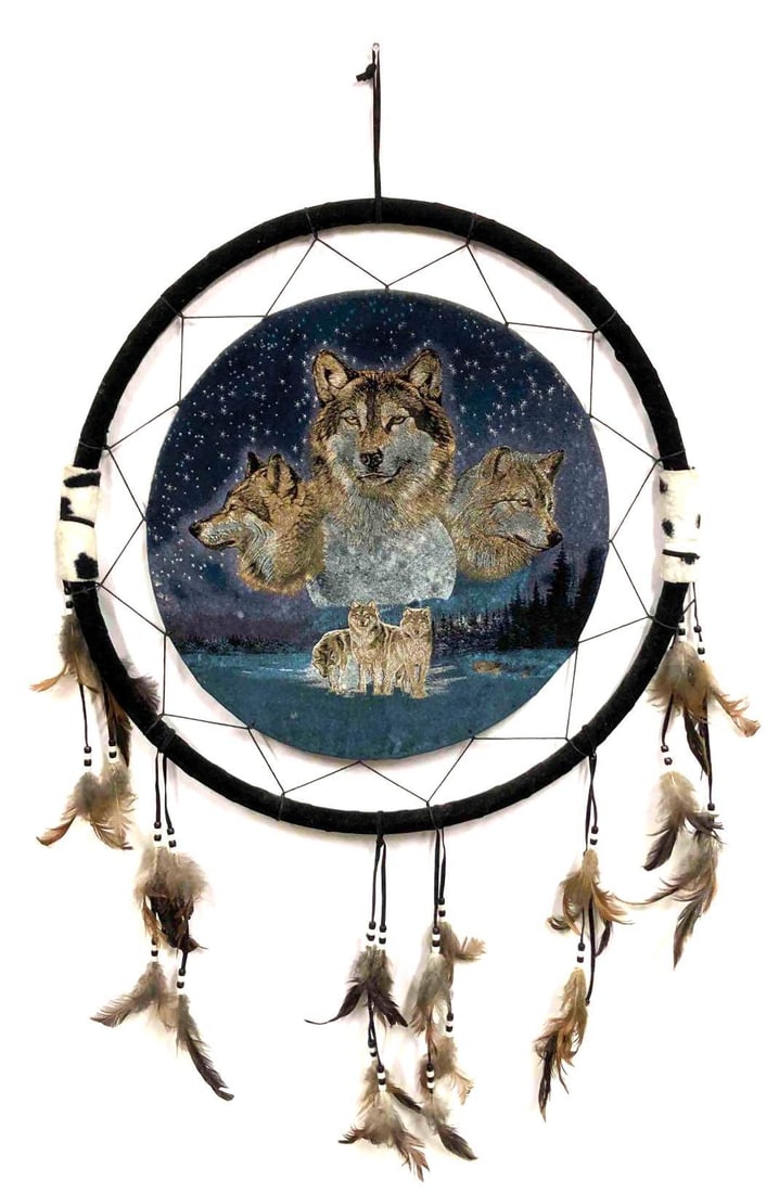 Dream Catcher With Wolves & Moon Design: This lot contains a dream catcher with wolves and a moon design. Dream catchers are one of the most widespread symbols associated with Native American culture. They are meant to protect users from bad