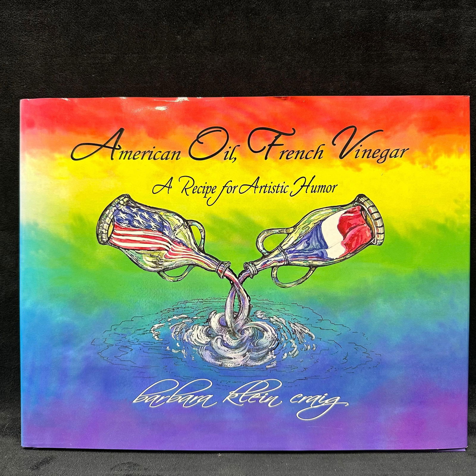 Signed Book American Oil French Vinegar A Recipe for Artistic Humor by Barbara Klein Craig: Signed with a personal inscription dated Dec 2005 to Michel Roux. Condition shows general handling wear, scuffing, and surface marks to the cover and jacket consistent with age. Interior pages appear